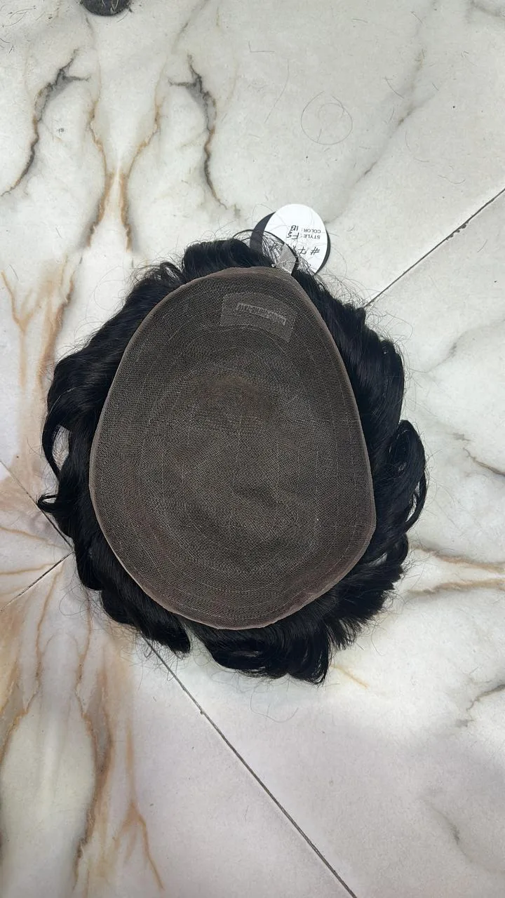 Dark hair system base with visible attachment clips
