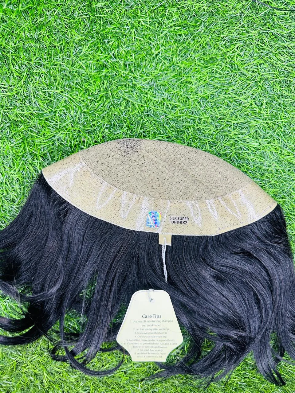 Supplied hairpiece showing the base edge and hanging hair length